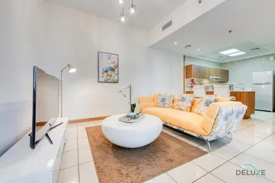 a living room with a couch and a table at Bright 1BR at Sulafa Tower Dubai Marina by Deluxe Holiday Homes in Dubai