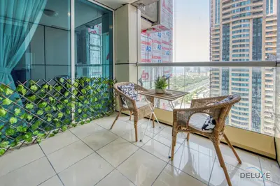 a balcony with a table and chairs on a building at Bright 1BR at Sulafa Tower Dubai Marina by Deluxe Holiday Homes in Dubai