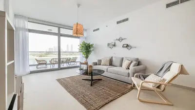 a living room with a couch and a table at Hashtag Holiday Home - Luxury 2BDR Apartment on The Palm Azure Residences in Dubai