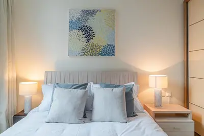 a bedroom with a white bed with two lamps at 2 Bedroom Apartment I Marina Diamond 4 I Close To Metro in Dubai