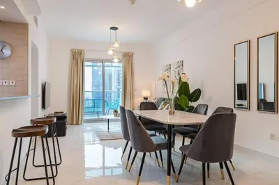 a kitchen and dining room with a table and chairs at 2 Bedroom Apartment I Marina Diamond 4 I Close To Metro in Dubai