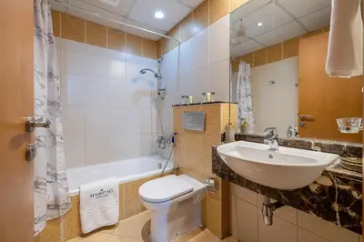 a bathroom with a sink and a toilet and a tub at 2 Bedroom Apartment I Marina Diamond 4 I Close To Metro in Dubai