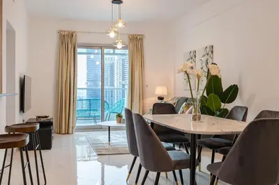 a dining room and living room with a table and chairs at 2 Bedroom Apartment I Marina Diamond 4 I Close To Metro in Dubai