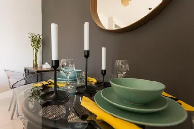 a dining table with a green bowl on top of it at Spacious 1BR with full Marina View in Dubai