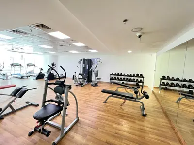 a gym with several treadmills and exercise bikes at Spacious 1BR with full Marina View in Dubai