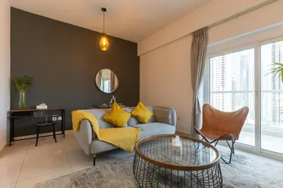 a living room with a couch and a table at Spacious 1BR with full Marina View in Dubai