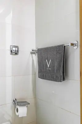 a bathroom with a towel hanging on the wall at Amazing Marina View - Near the Beach! in Dubai