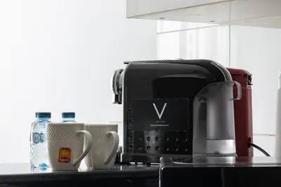a kitchen counter with a coffee maker and a coffee pot at Amazing Marina View - Near the Beach! in Dubai