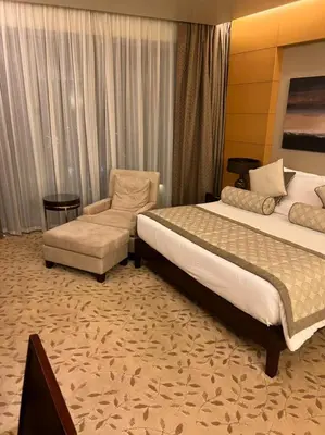 a hotel room with two beds and a chair at Address Dubai Mall Fashion Avenue Studio 17 floor in Dubai
