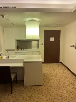 a large kitchen with a counter and a door at Address Dubai Mall Fashion Avenue Studio 17 floor in Dubai