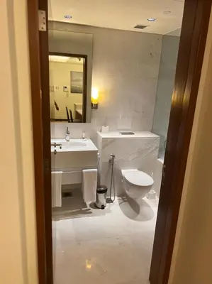 a bathroom with a sink and a toilet and a mirror at Address Dubai Mall Fashion Avenue Studio 17 floor in Dubai