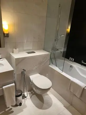 a bathroom with a toilet and a sink and a tub at Address Dubai Mall Fashion Avenue Studio 17 floor in Dubai