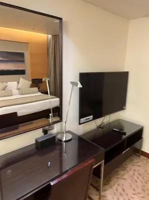 a bedroom with a desk with a bed and a large mirror at Address Dubai Mall Fashion Avenue Studio 17 floor in Dubai