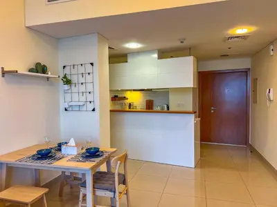 a kitchen and dining room with a table and chairs at Exquisite, luxe 1BD Apartment, Unparalleled Sea Views, Prime Dubai Marina Location & Full Kitchen by 
