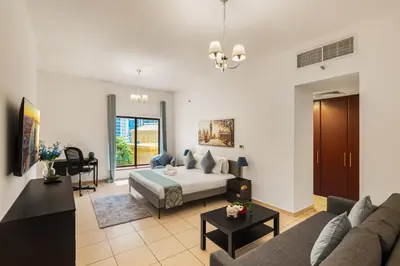 a living room with a bed and a couch at Beautiful 2BR & 4BR Apartments on JBR Beach, Walking Distance to Bluewaters Island - By Sunkissed Holiday Homes in Dubai