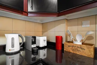a kitchen counter with two coffees and a coffee maker at Beautiful 2BR & 4BR Apartments on JBR Beach, Walking Distance to Bluewaters Island - By Sunkissed Holiday Homes in Dubai