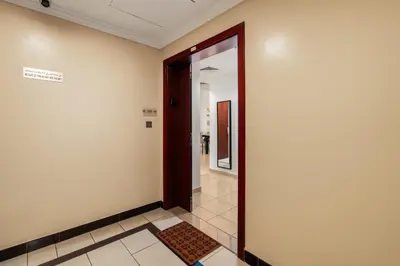 a hallway with a door and a tile floor at Beautiful 2BR & 4BR Apartments on JBR Beach, Walking Distance to Bluewaters Island - By Sunkissed Holiday Homes in Dubai