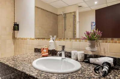 a bathroom counter with a sink and a mirror at Beautiful 2BR & 4BR Apartments on JBR Beach, Walking Distance to Bluewaters Island - By Sunkissed Holiday Homes in Dubai