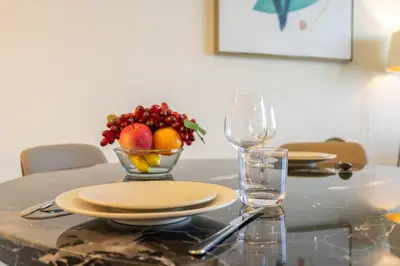 a table with a bowl of fruit on top of it at Exquisite Apartment Minutes Away from the Beach in Dubai