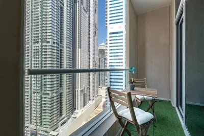 a balcony with a bench and a view of a city at Charming Apartment in Central Dubai Marina in Dubai
