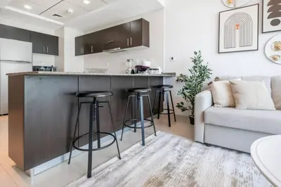 a kitchen and living room with a couch and a counter at Beach apartment in Dubai in Dubai