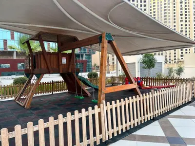 a swing set under a tent with a fence at Waterfront Yachts View Studio in Bay Central, Dubai Marina in Dubai