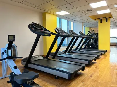 a row of tread machines in a gym at Waterfront Yachts View Studio in Bay Central, Dubai Marina in Dubai