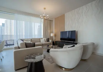 a living room with a couch and a tv at Nasma Luxury Stays - Harbour Gate Tower 1 in Dubai