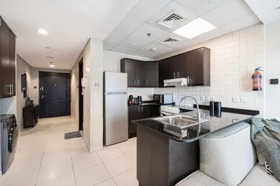 a kitchen with a sink and a refrigerator at Lovely Dubai Eye & Sea View, 3 mints to beach in Dubai