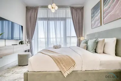 a bedroom with a large bed and a large window at Calm Studio at Carson C DAMAC Hills Dubailand by Deluxe Holiday Homes in Dubai
