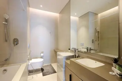a bathroom with a sink and a toilet and a shower at Livbnb - Lush 2BR Suite with Sea and Ain View in Address JBR in Dubai