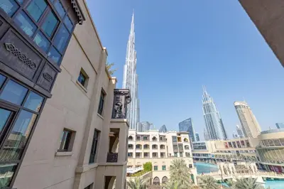 a building in front of a city skyline with skyscrapers at 1BDR apartment with Burj Khalifa View I Walking Distance to Dubai Mall I Tajeer in Dubai
