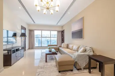 a living room with a couch and a table at Spacious 2BDR Apartment in Business Bay Habtoor City in Dubai
