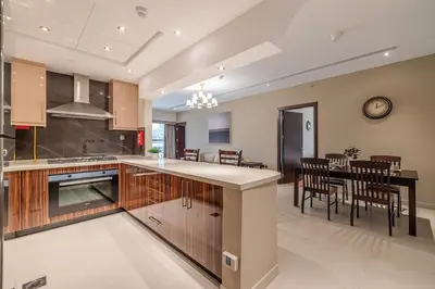 a kitchen and dining room with a table and chairs at Spacious 2BDR Apartment in Business Bay Habtoor City in Dubai