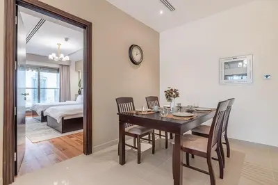 a dining room with a table and chairs and a bedroom at Spacious 2BDR Apartment in Business Bay Habtoor City in Dubai