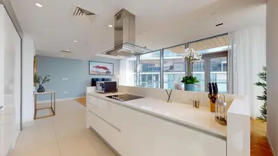 a kitchen with white counters and a large window at Bluewaters Island 2 and 1 BDR Apart with Sea Views in Dubai