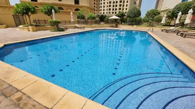 a large blue swimming pool in a building at Luxury Beachfront 2Bd Apt, Shams, JBR in Dubai