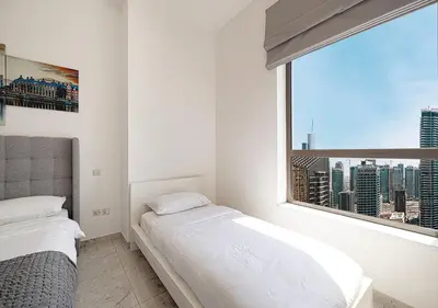 a bedroom with two beds and a large window at Luxury Beachfront 2Bd Apt, Shams, JBR in Dubai
