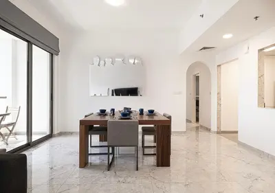 a dining room with a wooden table and chairs at Luxury Beachfront 2Bd Apt, Shams, JBR in Dubai