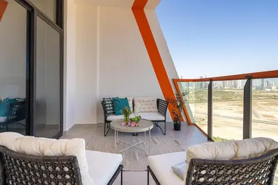 a living room with couches and a table and chairs at Frank Porter - Binghatti Avenue in Dubai