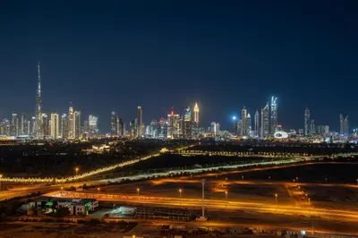 a night view of a city with lights at Frank Porter - Binghatti Avenue in Dubai