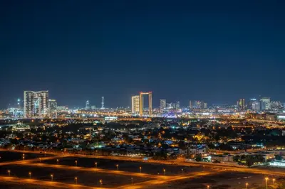 a view of a city at night with lights at Frank Porter - Binghatti Avenue in Dubai
