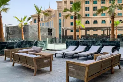 a group of chairs and tables in front of a building at Frank Porter - Binghatti Avenue in Dubai