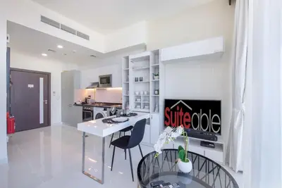 a kitchen with a table and chairs in a room at Breathtaking view compact & modern spacious studio in Dubai