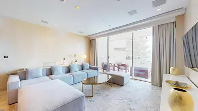 a living room with a couch and a table at FIVE Palm South -Opulent Two Bedroom with Sea View in Dubai