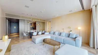 a living room with a couch and a table at FIVE Palm South -Opulent Two Bedroom with Sea View in Dubai