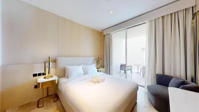 a hotel room with a bed and a chair at FIVE Palm South -Opulent Two Bedroom with Sea View in Dubai