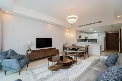 a living room with a couch and a table at Kasco Homes Waves Tower Business Bay in Dubai