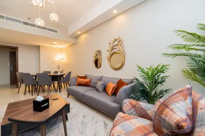 a living room with a couch and a table at Kasco Homes Waves Tower Business Bay in Dubai