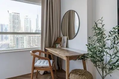 a desk in a room with a mirror and a window at GuestReady - Bohemian Apt with Marina View in Dubai
